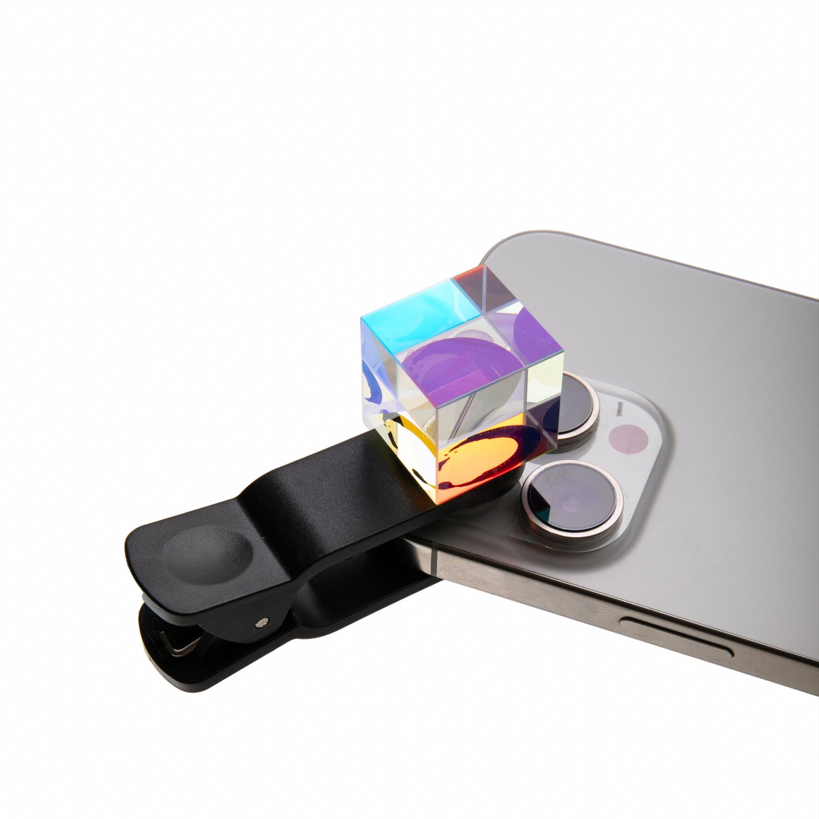 Phone camera lens protector with crystal cube attachment on a white background