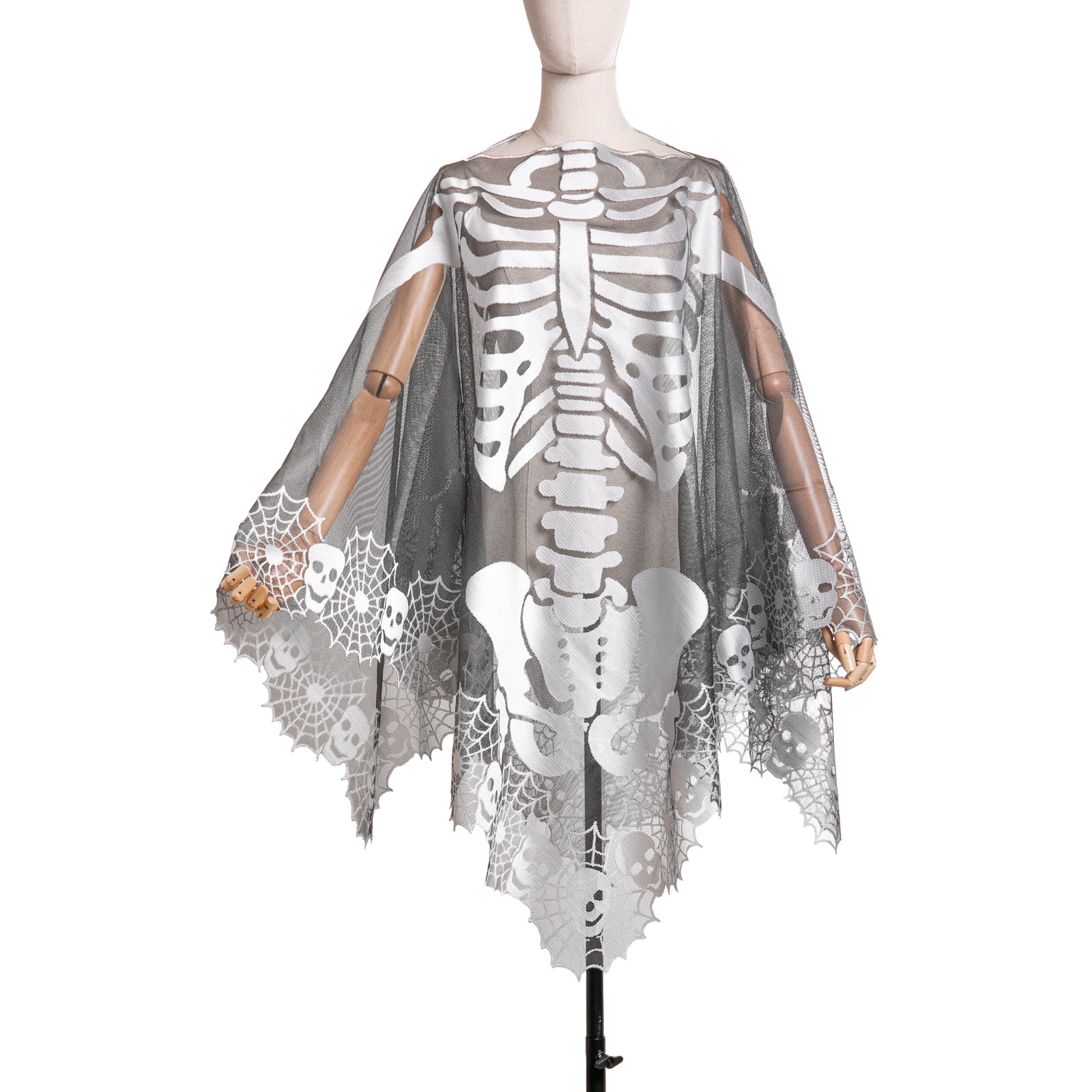 A mannequin wearing a Skeleton Lace Poncho with a life-size skeleton design, accented by cobweb and skull border in pewter and black colors.