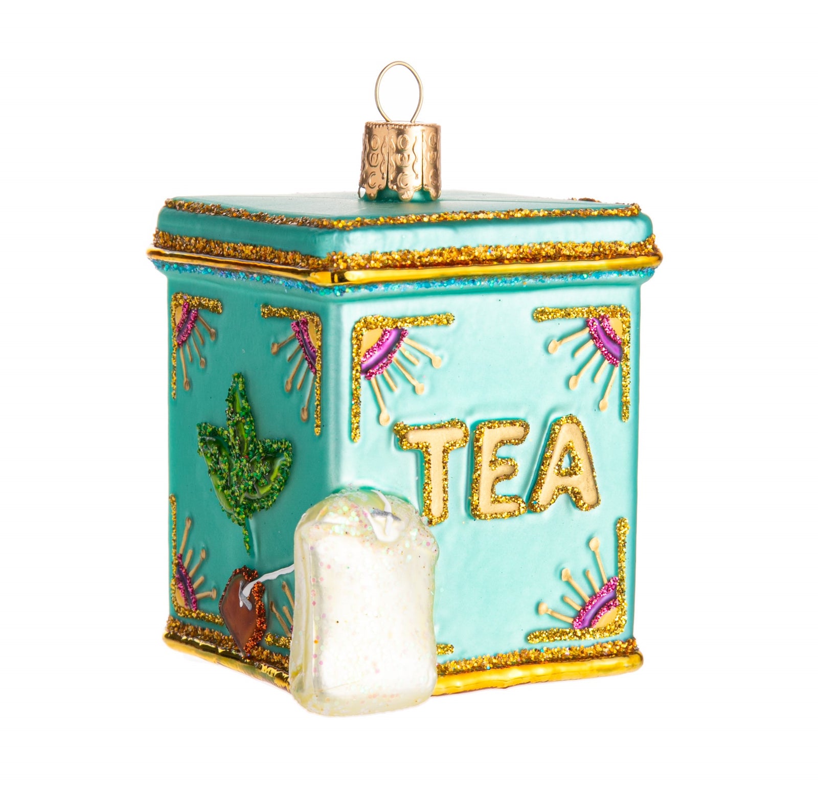 This delightfully sparkly vintage style tea-tin ornament is perfect for any tea enthusiast.   With hand-glittered details, including a miniature tagged tea bag! Hand finished, glass ornament. Dimensions: 2.5" x 2".