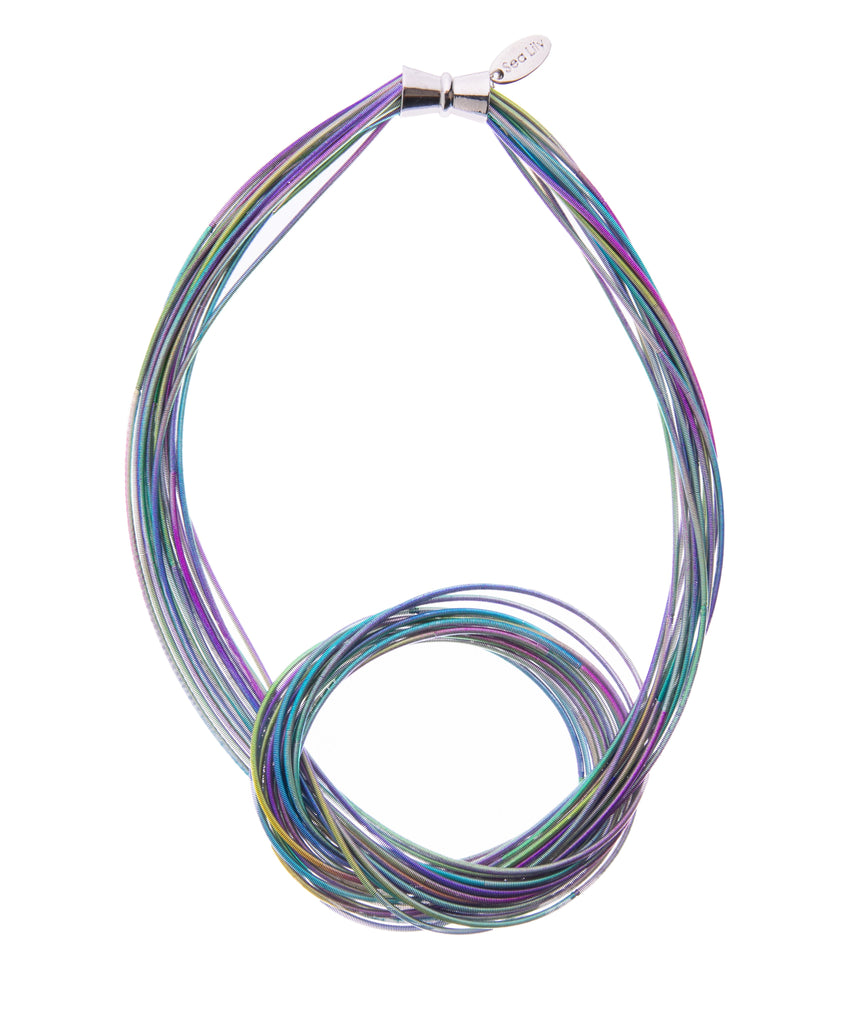 Even if you attempted the piano as a kid and never followed through with it, you can still wear this unique necklace made of actual piano wire! In rainbow colors featuring a twist detail and magnetic clasp, this piano wire necklace would be pretty dressed down with a basic tee or dressed up with evening wear. 9" long.