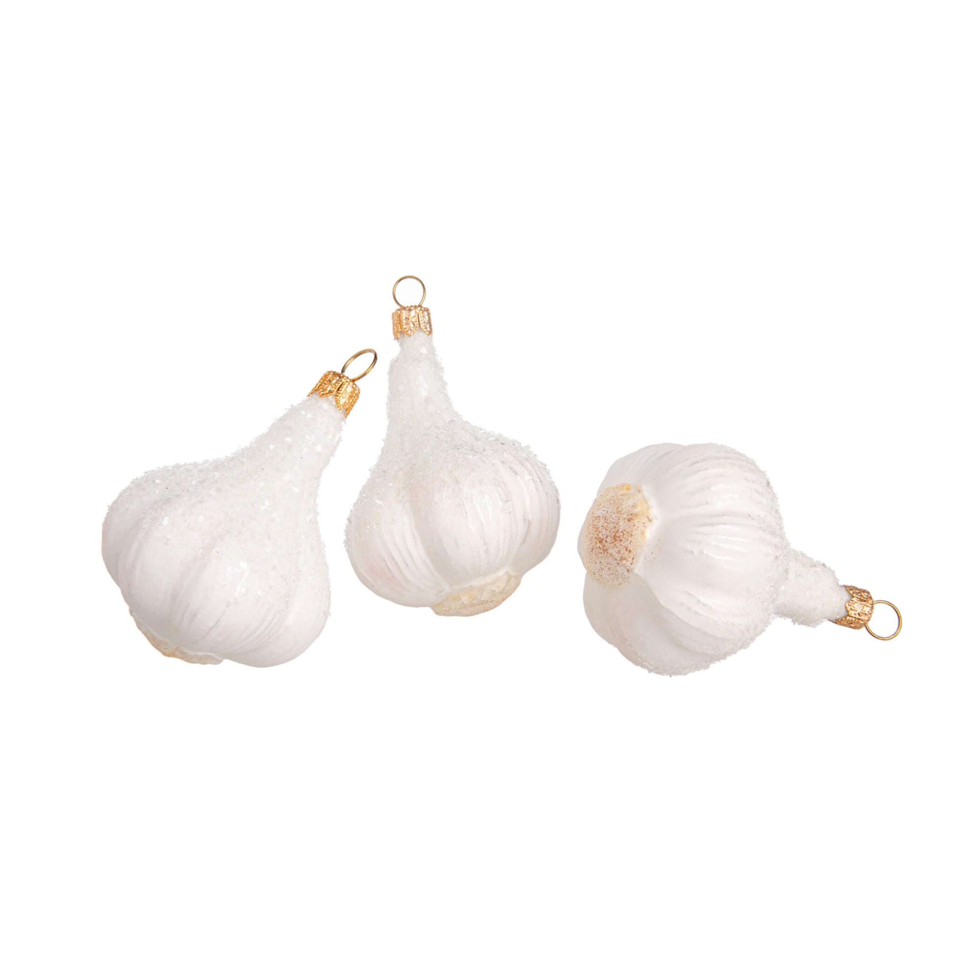 The humble garlic bulb gets a glittering makeover in this enchanting ornament. This carefully crafted glass ornament is generously sprinkled with iridescent glitter and is sure to add a wonderfully whimsical touch to your holiday decor. *May also keep vampires at bay. Hand crafted glass ornament. Dimensions: 3" x 2".