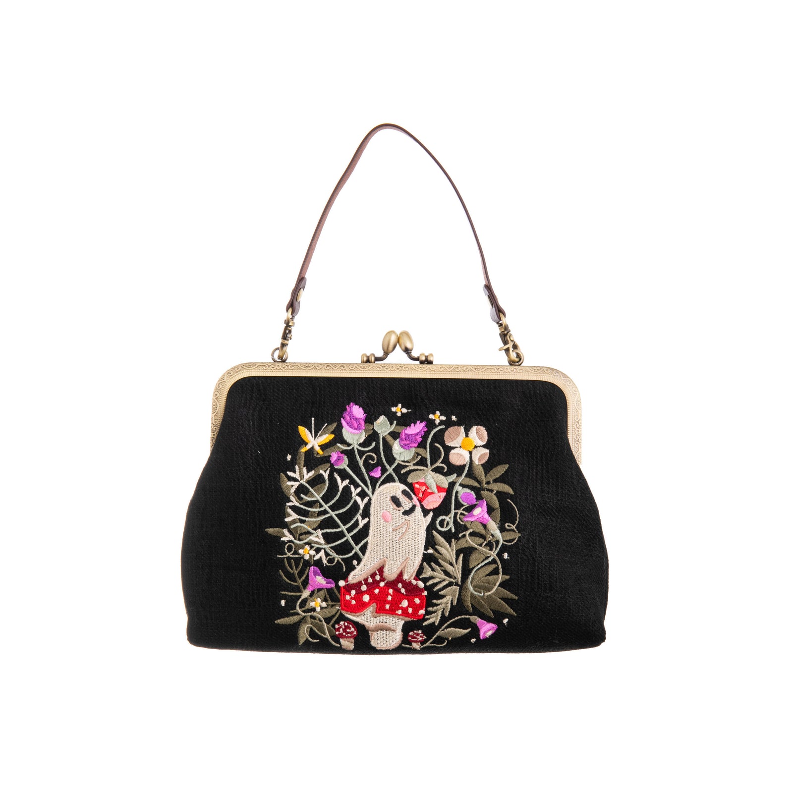 Black handbag with embroidered design of a ghost and flowers on a white background