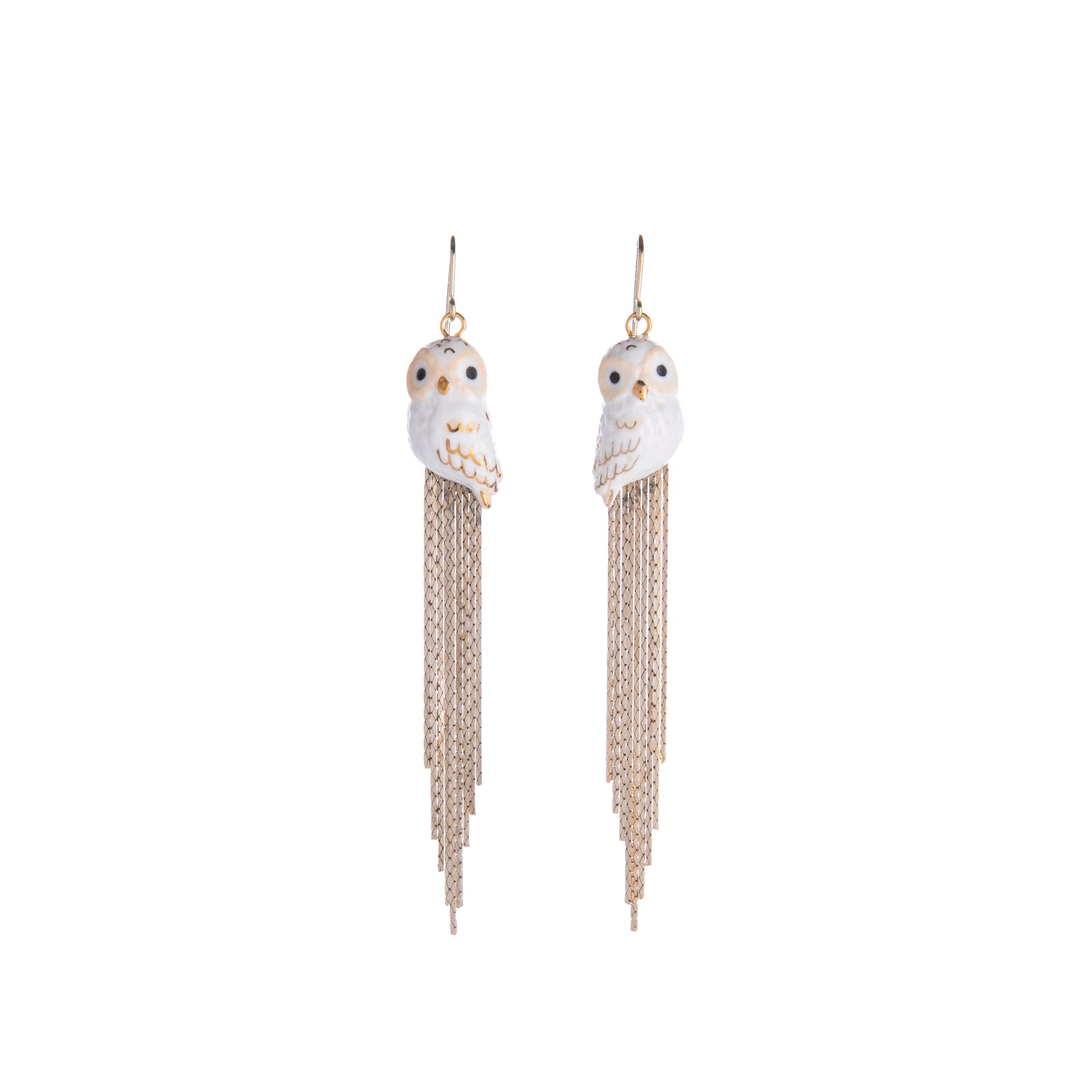 Make a statement in these shimmery white and gold owl earrings!    With cascading gold fringe, these dangly earrings feature hand-painted owls. Pair them with any outfit to level up your look and serve glamour owl realness.  Lead and Nickel-free Material: Porcelain, Gold-plated Brass Designed in Toulouse, France