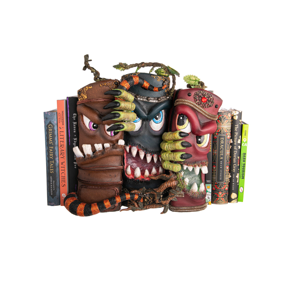 Three monster-themed bookends with books on a white background