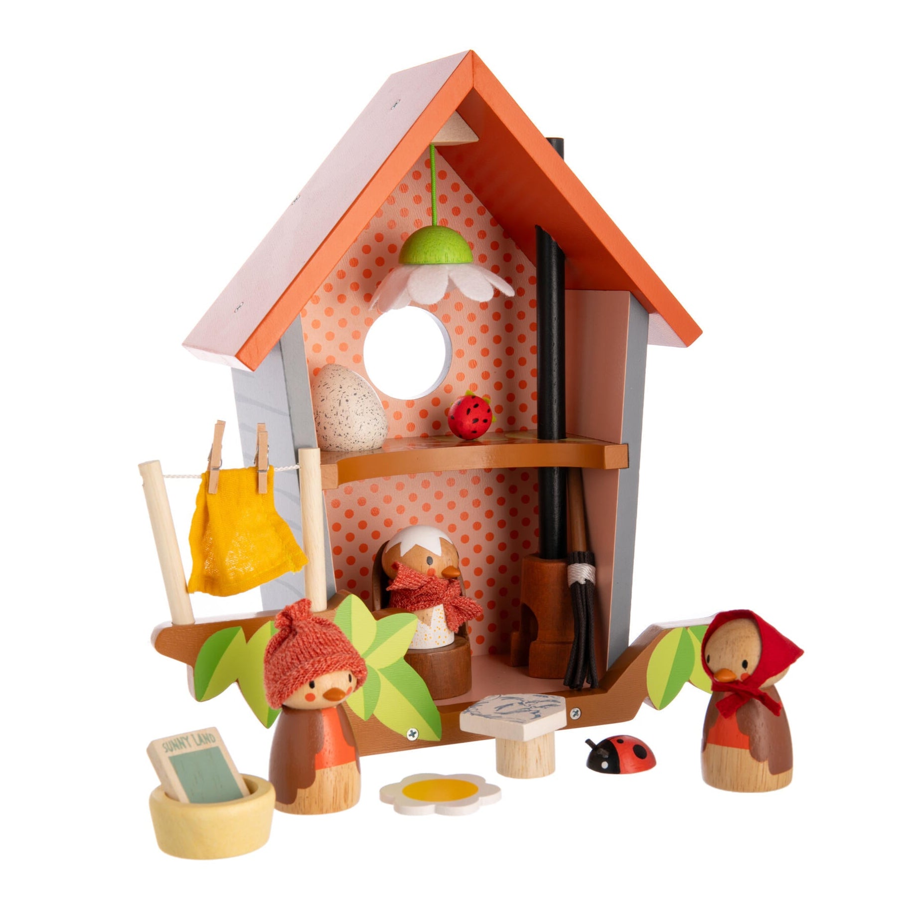 Toy playset with a small house, dolls, and various items on a white background