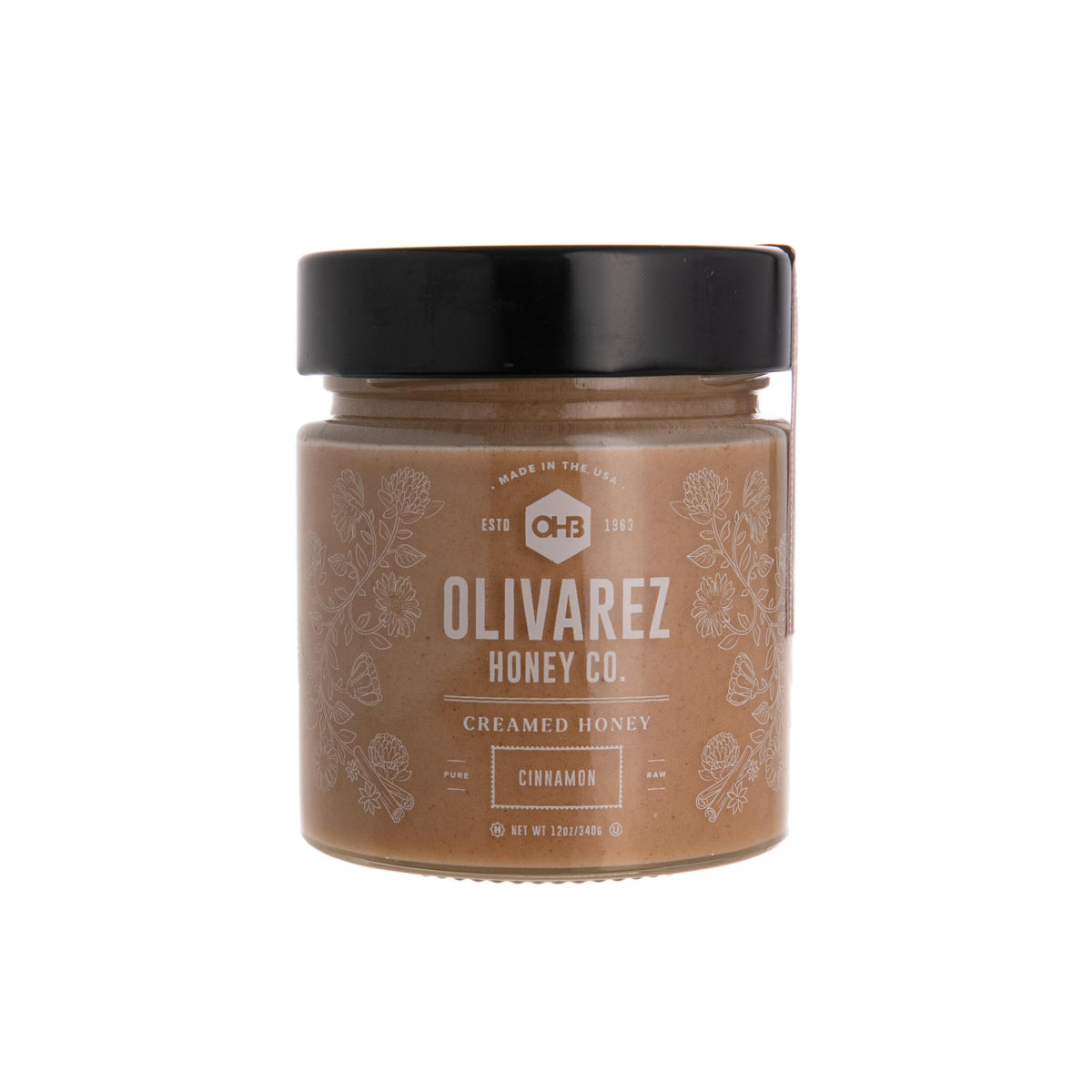 Jar of Olivarez Honey Co. cinnamon creamed honey on a white background