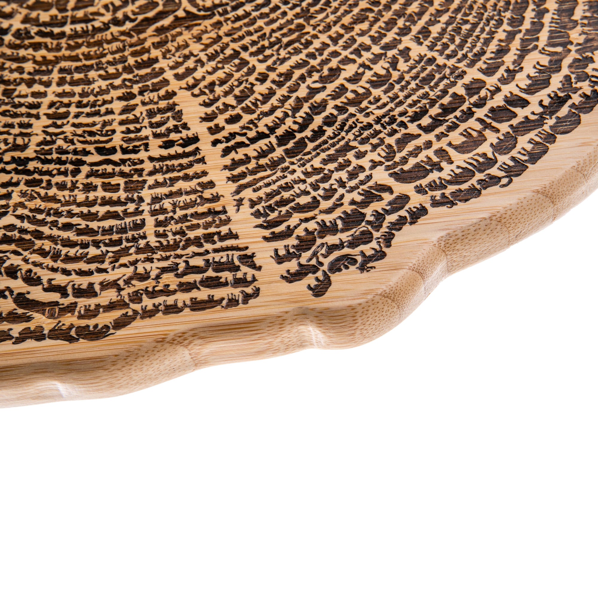 A cutting board shaped like a cross-section of a tree trunk showing annual rings on a white background