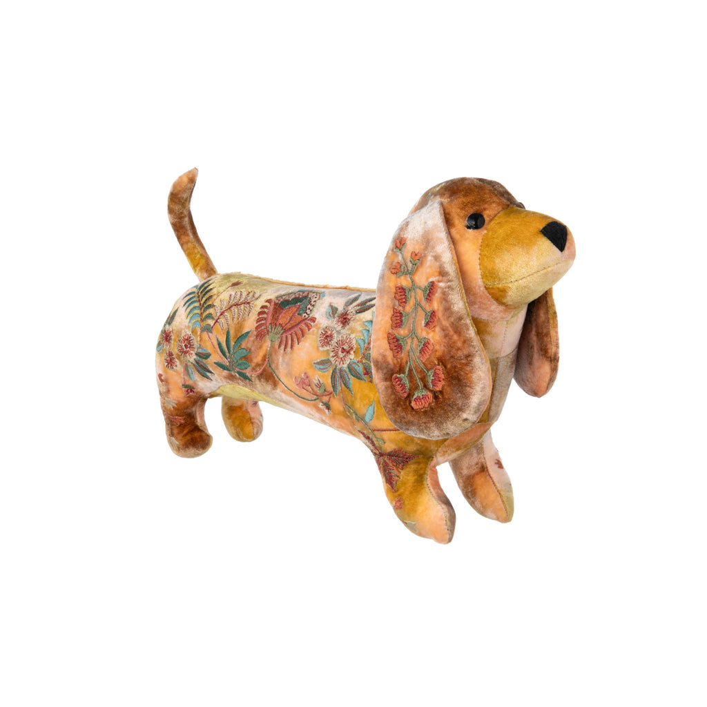 Add a little luxurious cute-ness to your life with this richly embroidered silk velvet Dachshund. This pretty pup works as either a home-decor piece or finishing touch to a baby's nursery. By Anke Drechsel, a German textile designer and internationally recognized brand, founded in 1986. Handmade. 100% silk. 15" x 8".