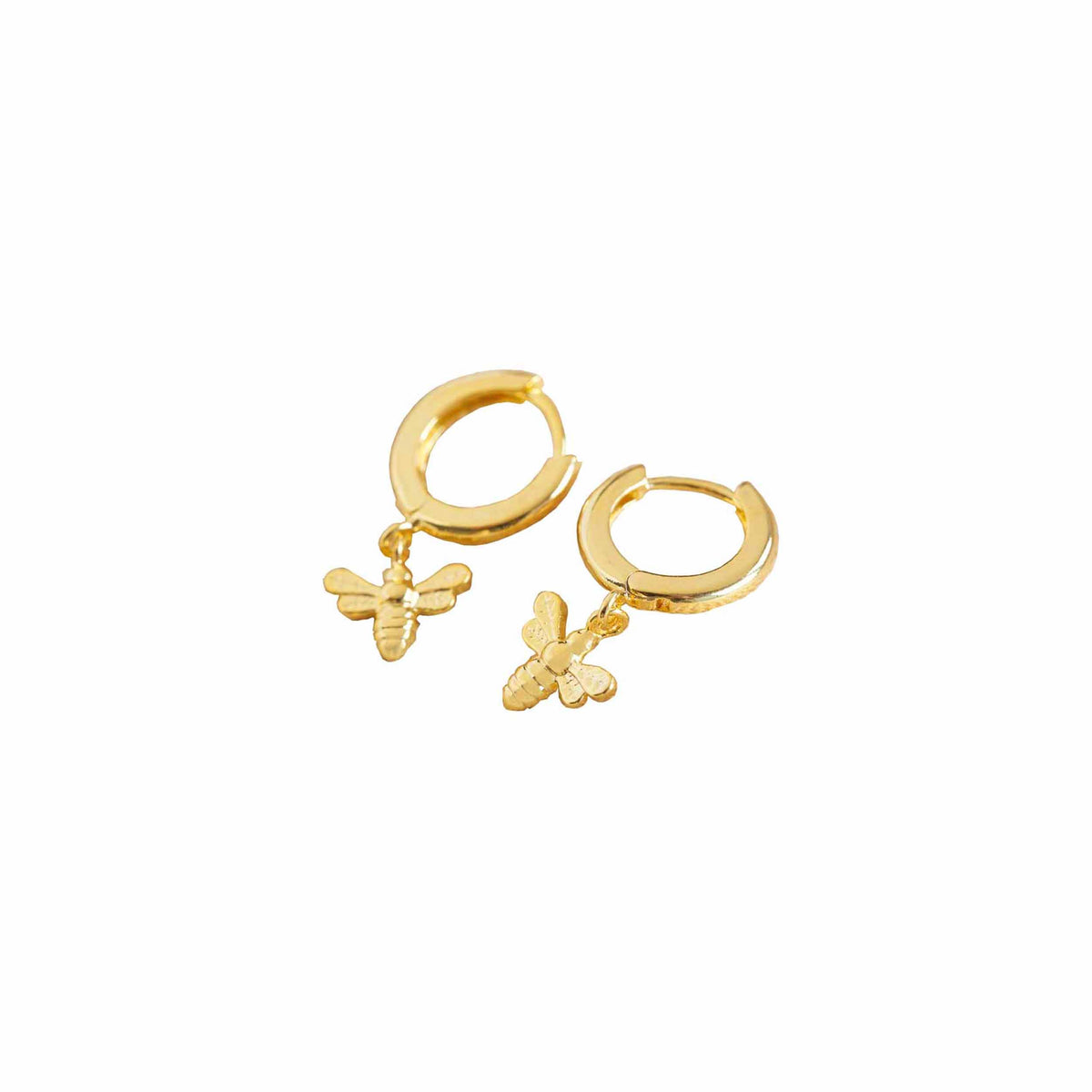 A pair of gold-plated hoop earrings with dangling bumblebee charms, on a white background.