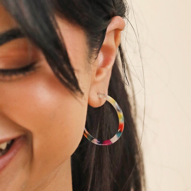 Make a statement with these gorgeous hoop earrings. Bold in color, you'll love these fun and unique hoop earrings made of resin, with a tortoiseshell design featuring red, blue, green, pink, orange, and other bright colors. Butterfly backs and hypoallergenic sterling silver posts. Dimensions: 1.5" x 1.5".