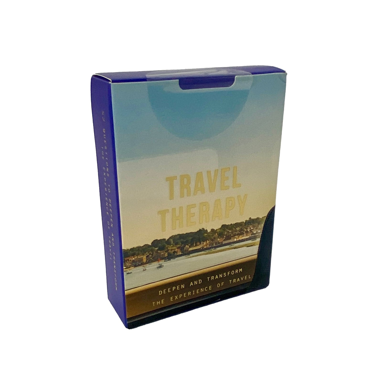 A boxed card deck labeled 'TRAVEL THERAPY' with an image of a calm travel scene on the packaging.