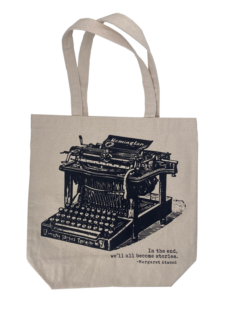 "In the end, we'll all become stories." --Margaret Atwood​ The perfect tote for every writer, featuring a vintage typewriter and inspiring quote, comes ready and willing to tote around all your bookish gear. Dimensions: 16" x 15 1/2" x 5" gusset, 22" handles Material: Natural cotton Made in the U.S.A.