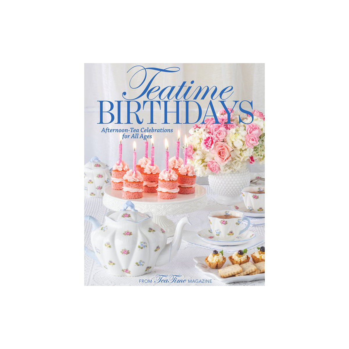 Teatime Birthdays cookbook cover featuring a white teapot, pink frosted cupcakes with candles, a floral arrangement, and tea cups on a table, with the title 'Teatime Birthdays' in blue script and serif text.
