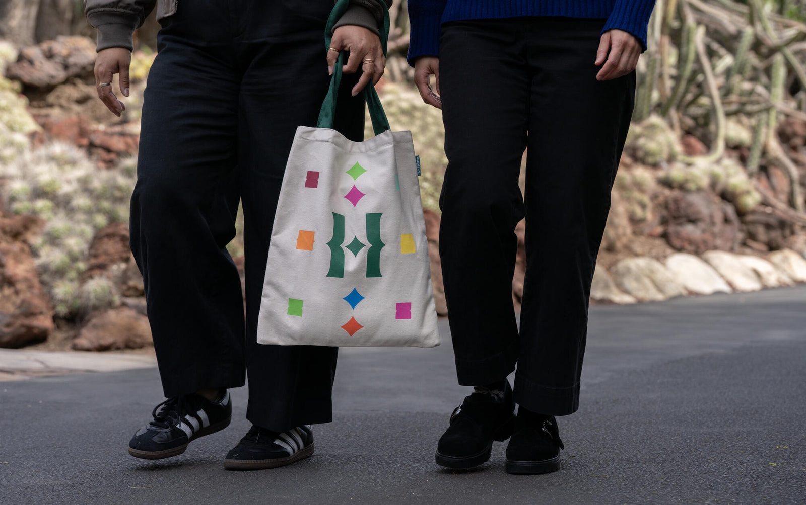 Our fun new Huntington H monogram tote is sprinkled shapes to add a pop of color to your farmers market shop, beach day, or library visit. Made from sturdy cotton canvas with reinforced straps and a handy interior slip pocket. Materials: 100% cotton canvas Dimensions: 13" x 15.5" Strap length 24.5" Huntington exclusive