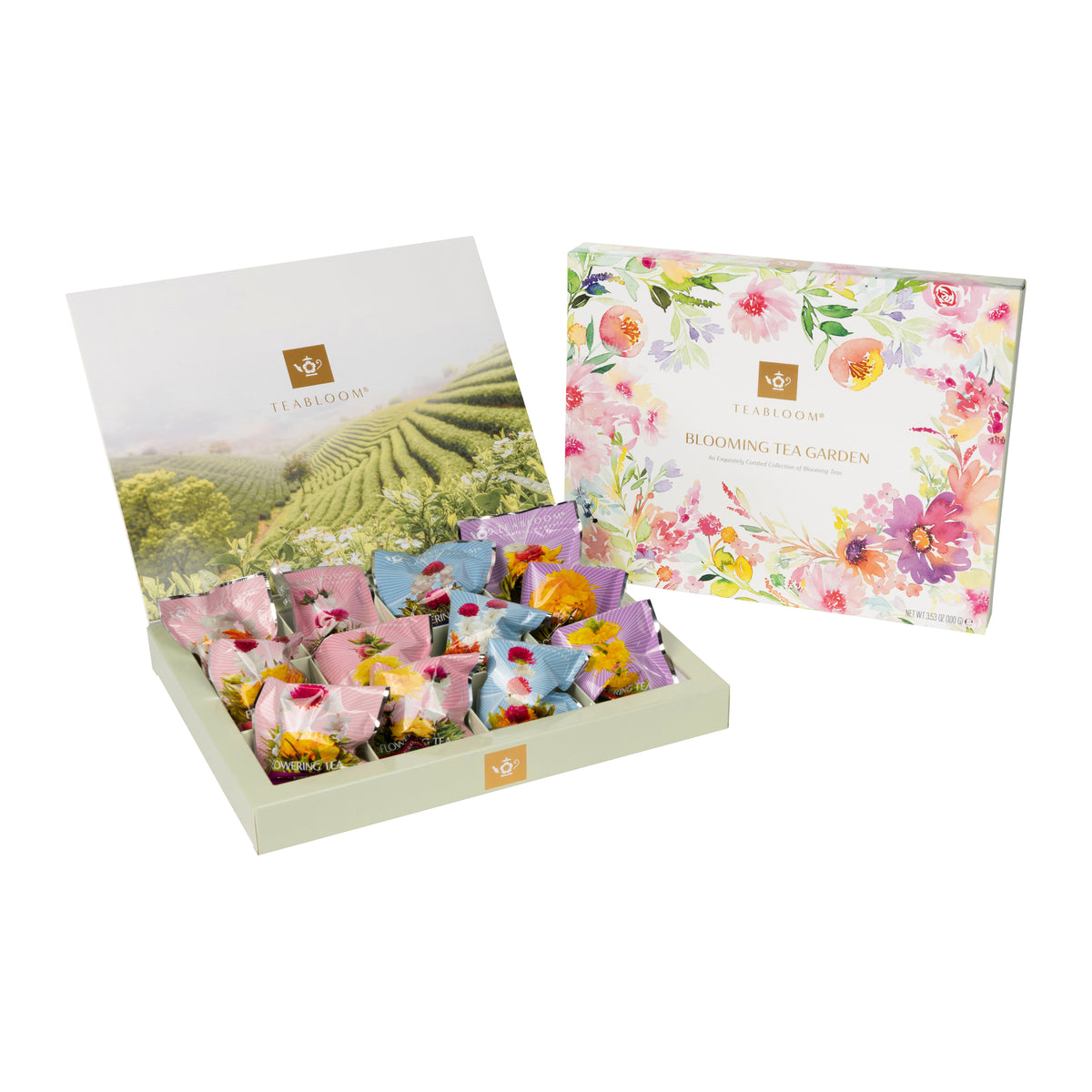 An open rectangular tea gift box with a light sage green base, displaying 12 individually wrapped tea bags arranged in a grid. The tea bags feature colorful floral designs in pink, orange, yellow, and blue.