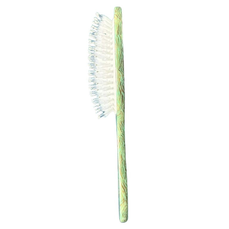 This delightful hairbrush is made of individually cut and formed eco-friendly cellulose acetate, and the waterlily design is individually hand painted with gold metallic accents. This 2-in-1 perfect daily brush is designed for all hair types + textures. featuring two types of bristles, it can be safely used on wet + dry hair.