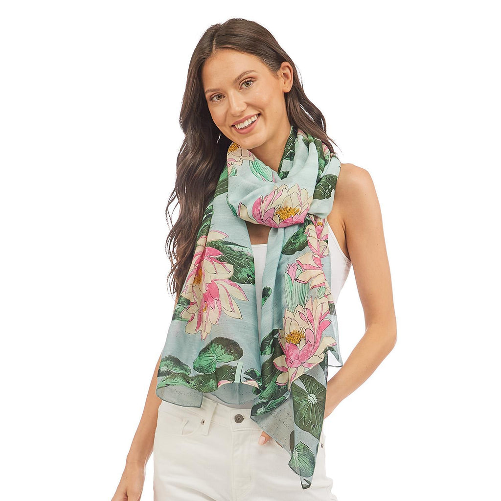This versatile scarf is a must-have for every season. It can be worn in a variety of ways including as a shawl, sarong and scarf. Features a water lily print on a soft mint / grey background. The fabric has a silk-like feel with a composition of 50% modal & 50% viscose, making it lightweight and soft. 40" W x 78".