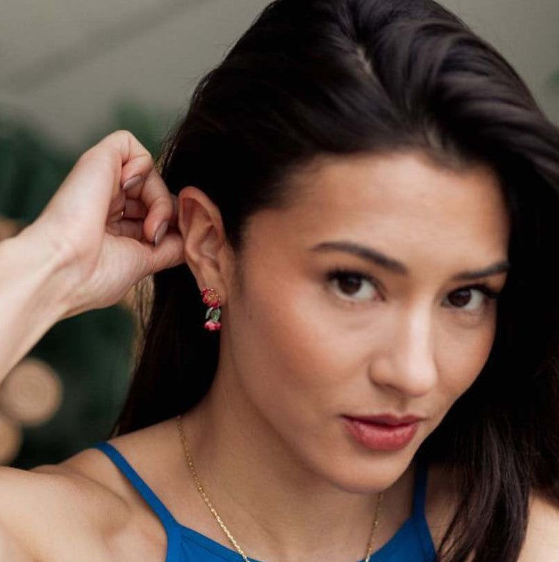 Pair of red flower-shaped earrings on a white background