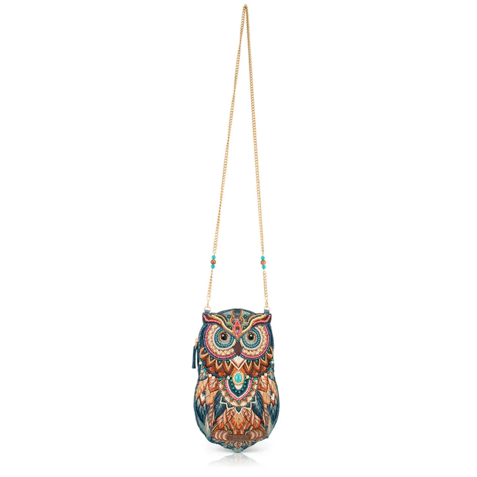 An owl-shaped crossbody bag with an intricate, colorful embroidered pattern in shades of blue, brown, gold, and teal, featuring a gold chain strap, set against a plain white background.
