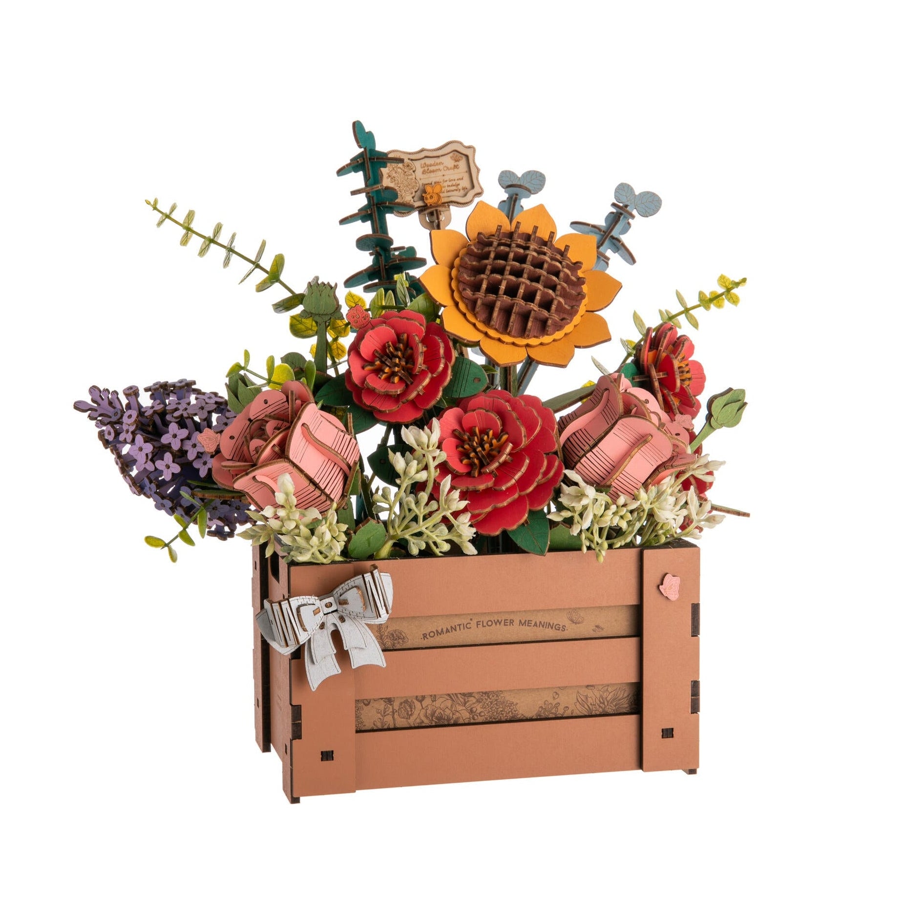 Decorative flower arrangement in a wooden crate on a white background