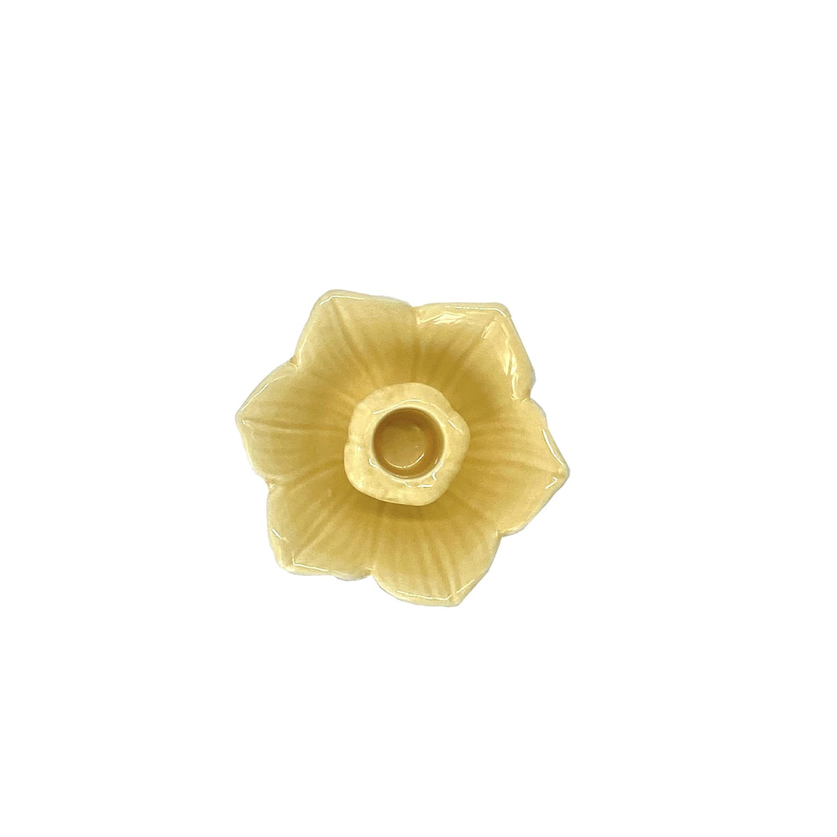 Yello daffodil flower-shaped candle holder on a white background