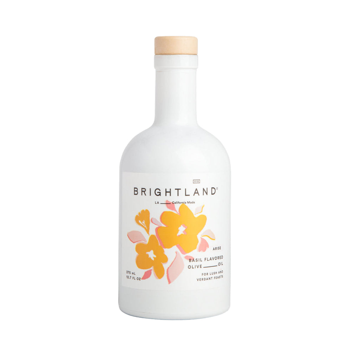 Brightland Basil Flavored Olive Oil in a white glass bottle with a light wood cap and a label featuring yellow and orange flowers.