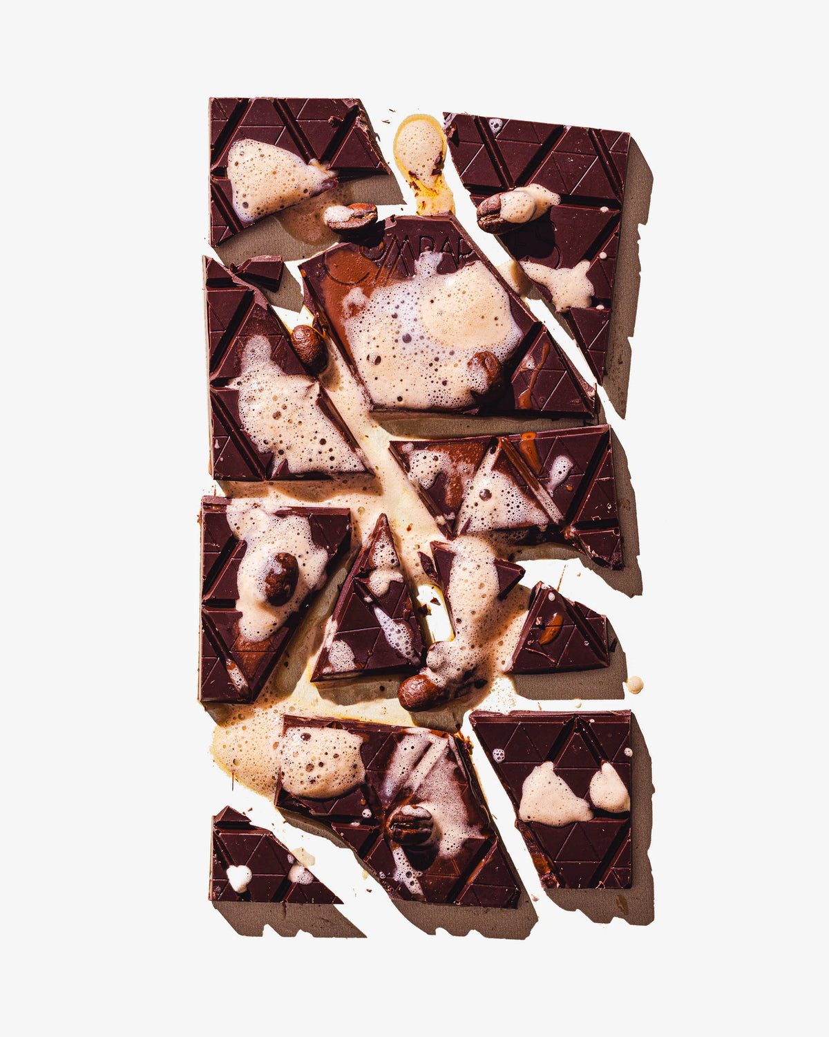 Chocolate bar with white and milk chocolate pieces on a light gray background