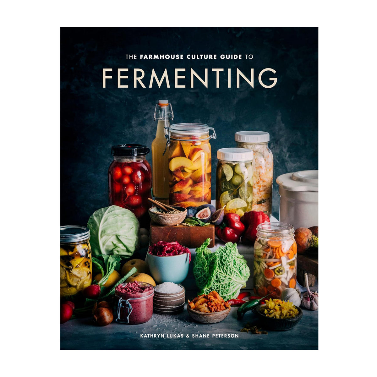 Book cover of &#39;The Farmhouse Culture Guide to Fermenting&#39; with jars and vegetables on a dark background