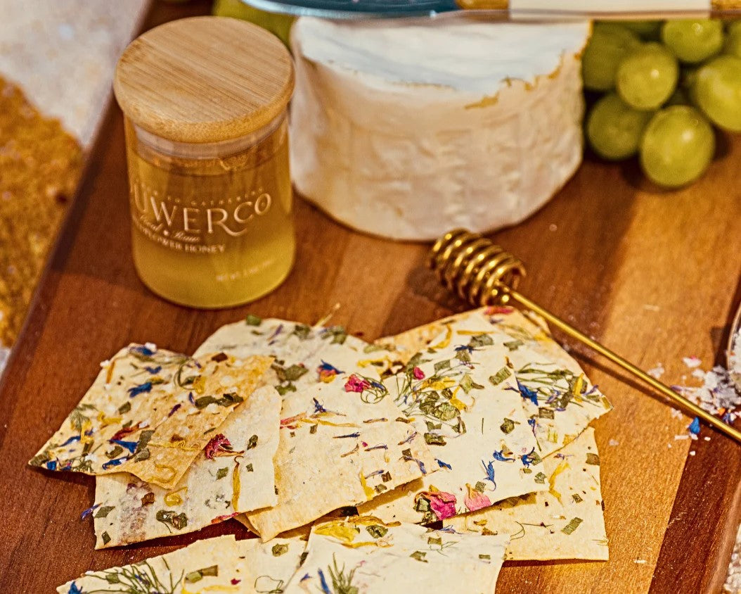 Flowerco artisinal crackers packaging with colorful floral design on a white background