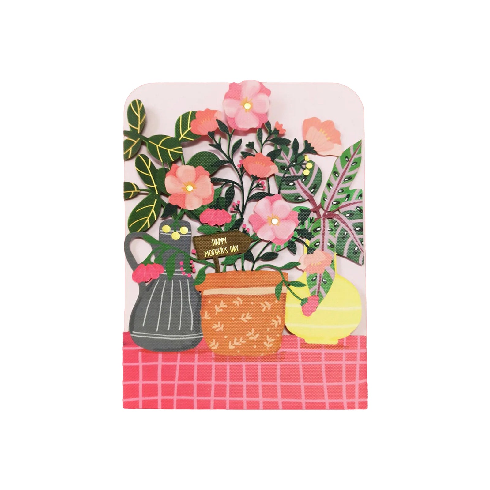 A die-cut Mother's Day card featuring a floral design with a pot of flowers, a watering can, and a lemon, adorned with gold foil details on a pink background.