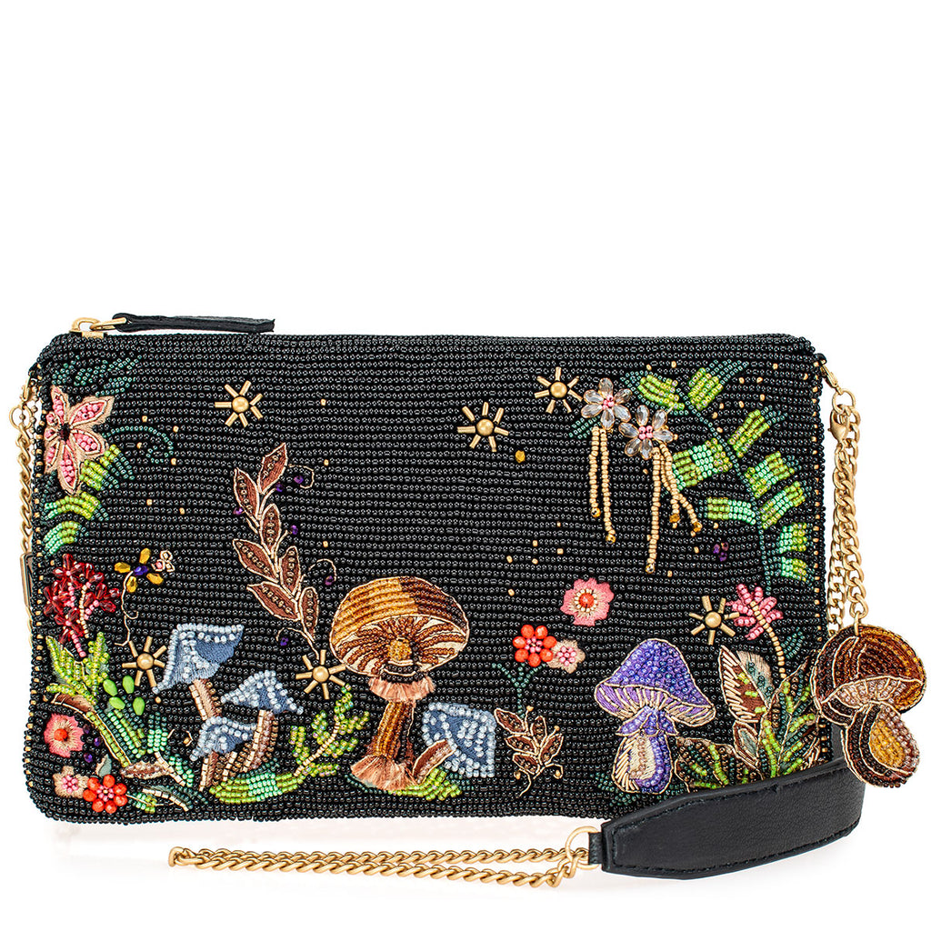 This nature-inspired crossbody handbag features intricate beading and embroidery to create a whimsical scene of colorful mushrooms and blooming flowers. This enchanting accessory captures the essence of a woodland adventure, adding a touch of magic and charm to your ensemble. Dimensions: 10" x 1" x 6" Strap length 49" 