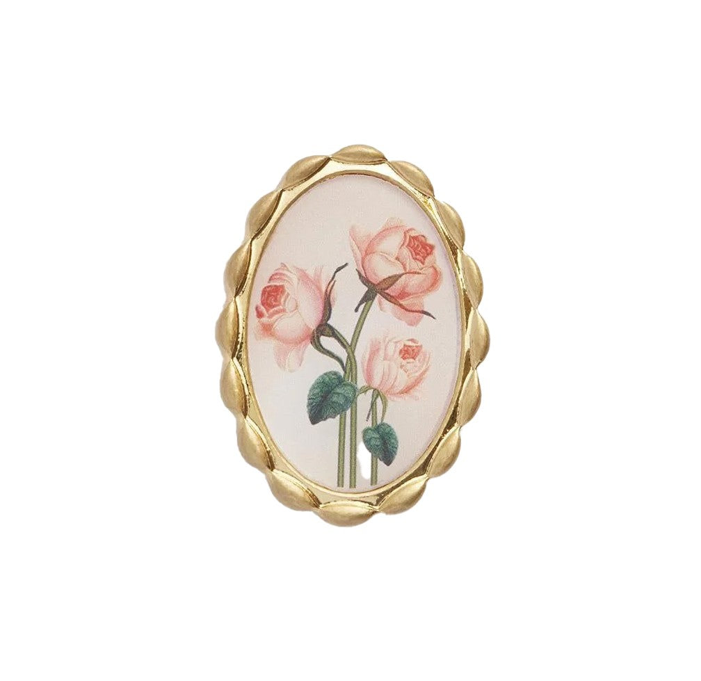Pin on a piece of history with this Framed Roses Brooch. Featuring Dr Robert John Thornton's painted rose illustrations from England’s Natural History Museum archives, this Victorian-inspired brooch is set in a timeless gold-tone oval hand-carved frame.