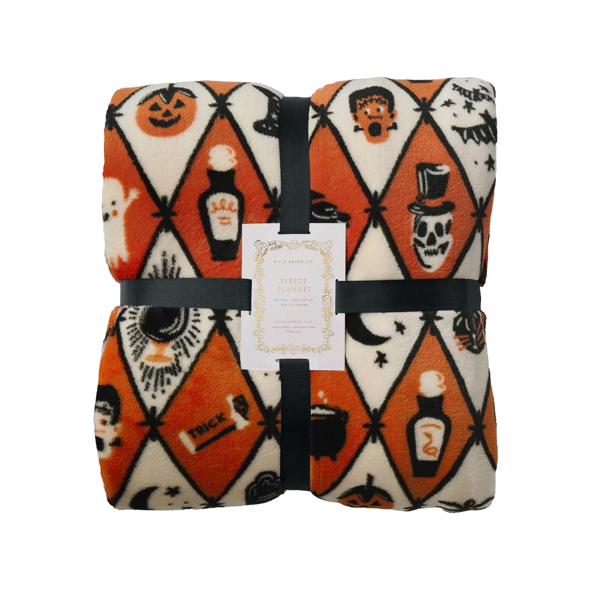 A folded Halloween-themed fleece blanket with an orange, cream, and black harlequin pattern featuring jack-o'-lanterns, ghosts, cauldrons, bottles, and bats, wrapped in a black ribbon with a product tag.
