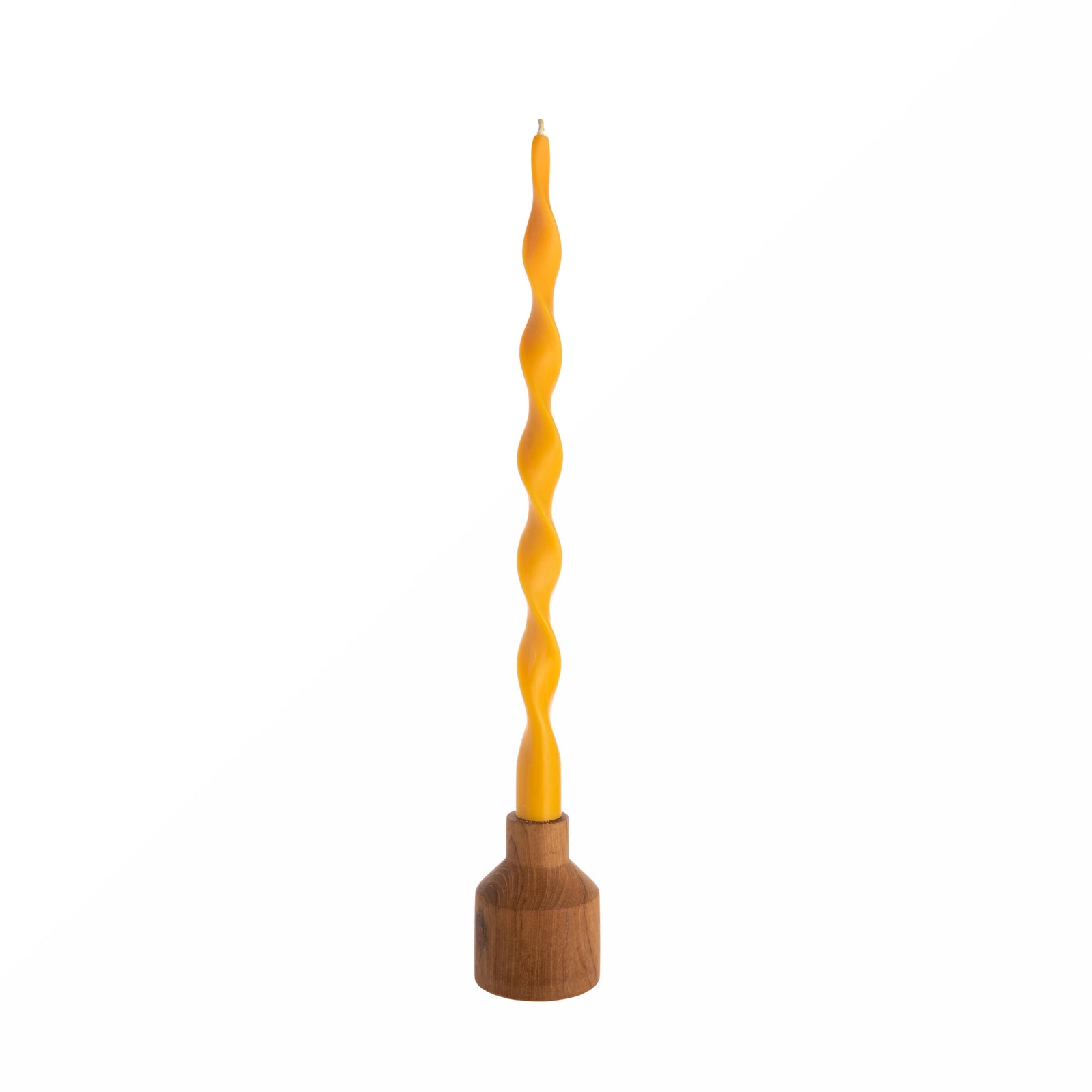 Twisted green candle with wooden base on a white background