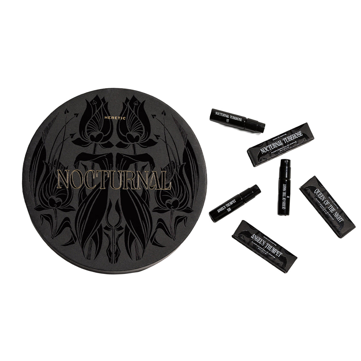 A black circular box with ornate floral artwork and the word 'NOCTURNAL' in gold lettering, shown next to five small black perfume samplers on a plain white background.