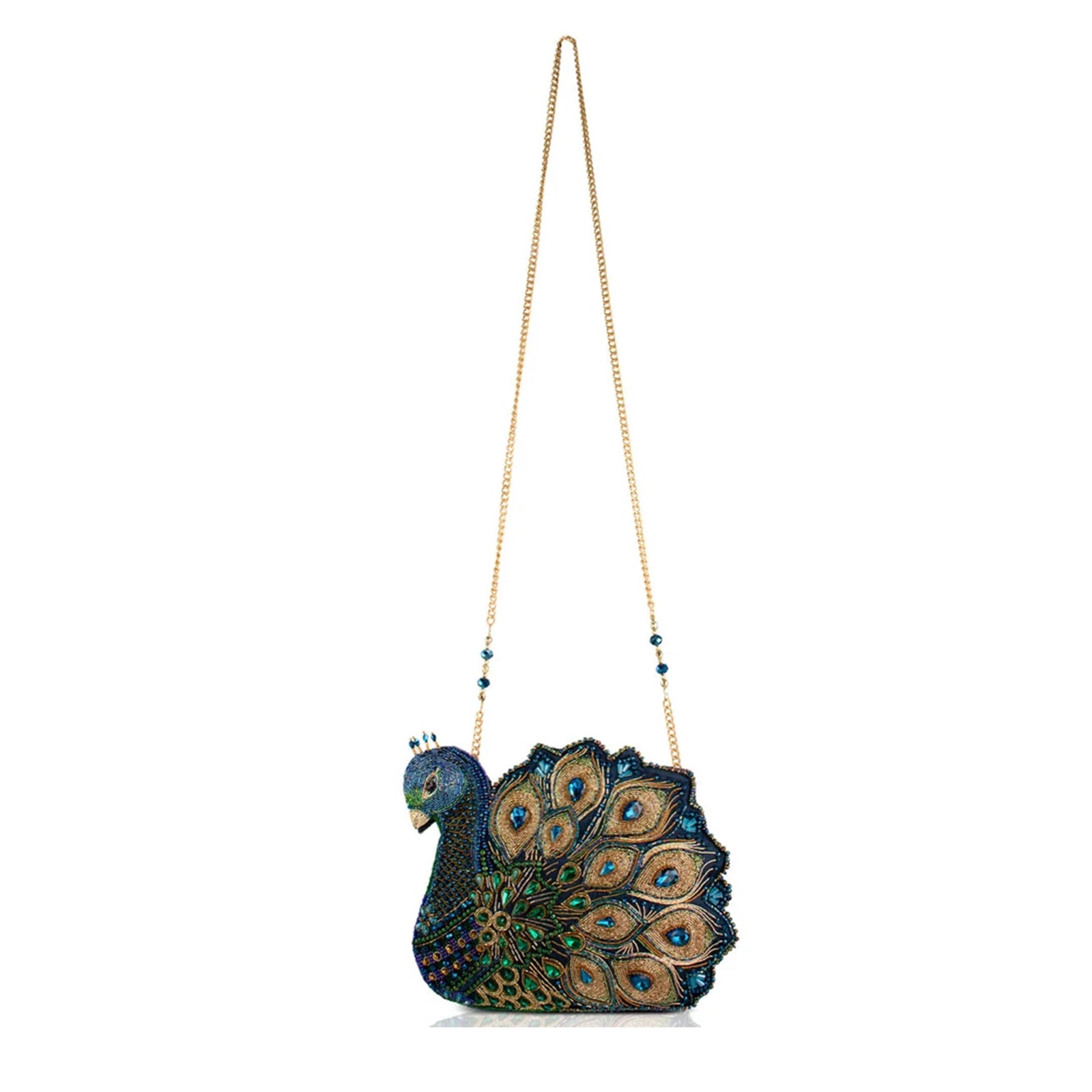 A beaded peacock-shaped evening clutch bag with a gold chain strap, featuring intricate blue, green, and gold beadwork on a white background.