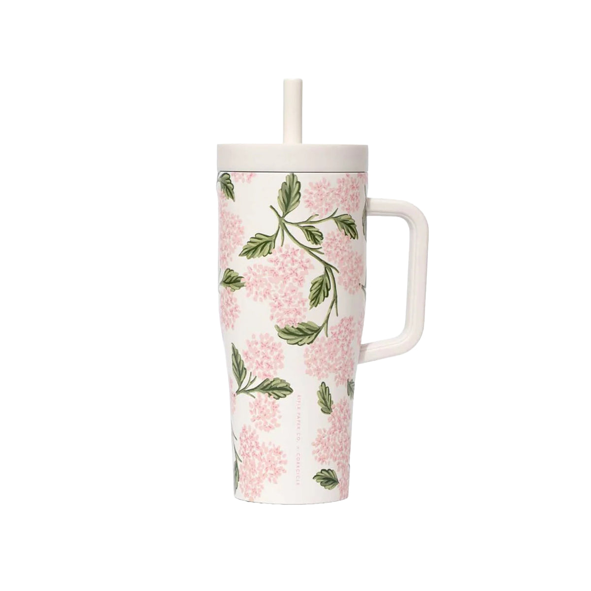 Floral-patterned mug with a straw on a white background
