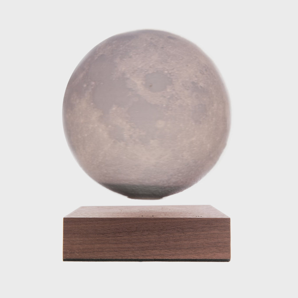 Create a fascinating focal point for any stylish home or office with this beautiful rotating moon lamp will amaze your guests and provide an uplifting glow for any space. The sphere, with its textured surface imitating that of the moon, slowly rotates in the space above a walnut wood base.