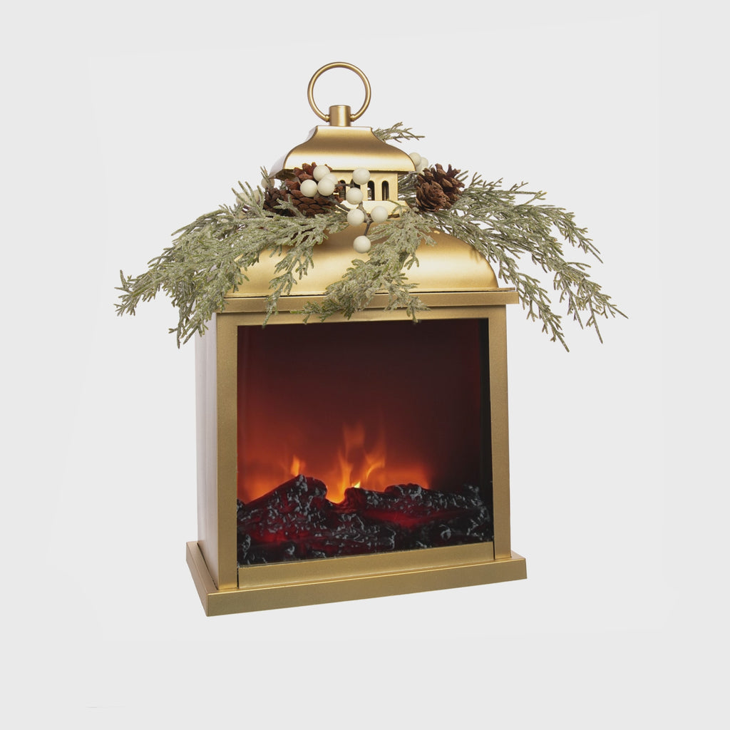 This delightful holiday lantern has LED lights which flicker to give a realistic fireside appearance. The lantern has a soft gold color, topped with a pine wreath. Yule logs inside the lantern complete the festive effect. Dimensions: 17" x 9" x 5.5" Includes a timer switch Requires 3 x size C batteries (not included).