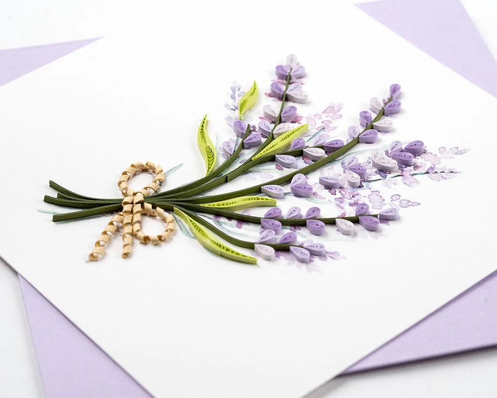 Greeting card with a bouquet of lavender with a gold bow on a white background with a lavender colored envelope