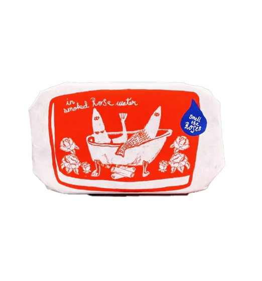 Discover this enchanting Smoked Rose Water candle, a unique blend of rustic and floral aromas. Housed in a whimsical sardine tin with delicate sardine-shaped candles inside with added shimmer, it combines the fresh fragrance of roses with the comforting scent of a campfire. Perfect for creating a serene ambiance or as a thoughtful gif