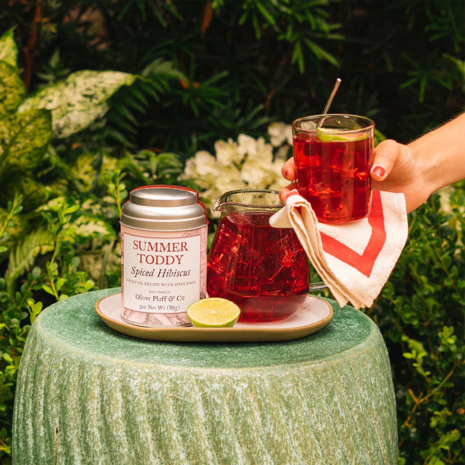 Spiced Hibiscus cocktail mix container with 'Summer Toddy' label on a white background