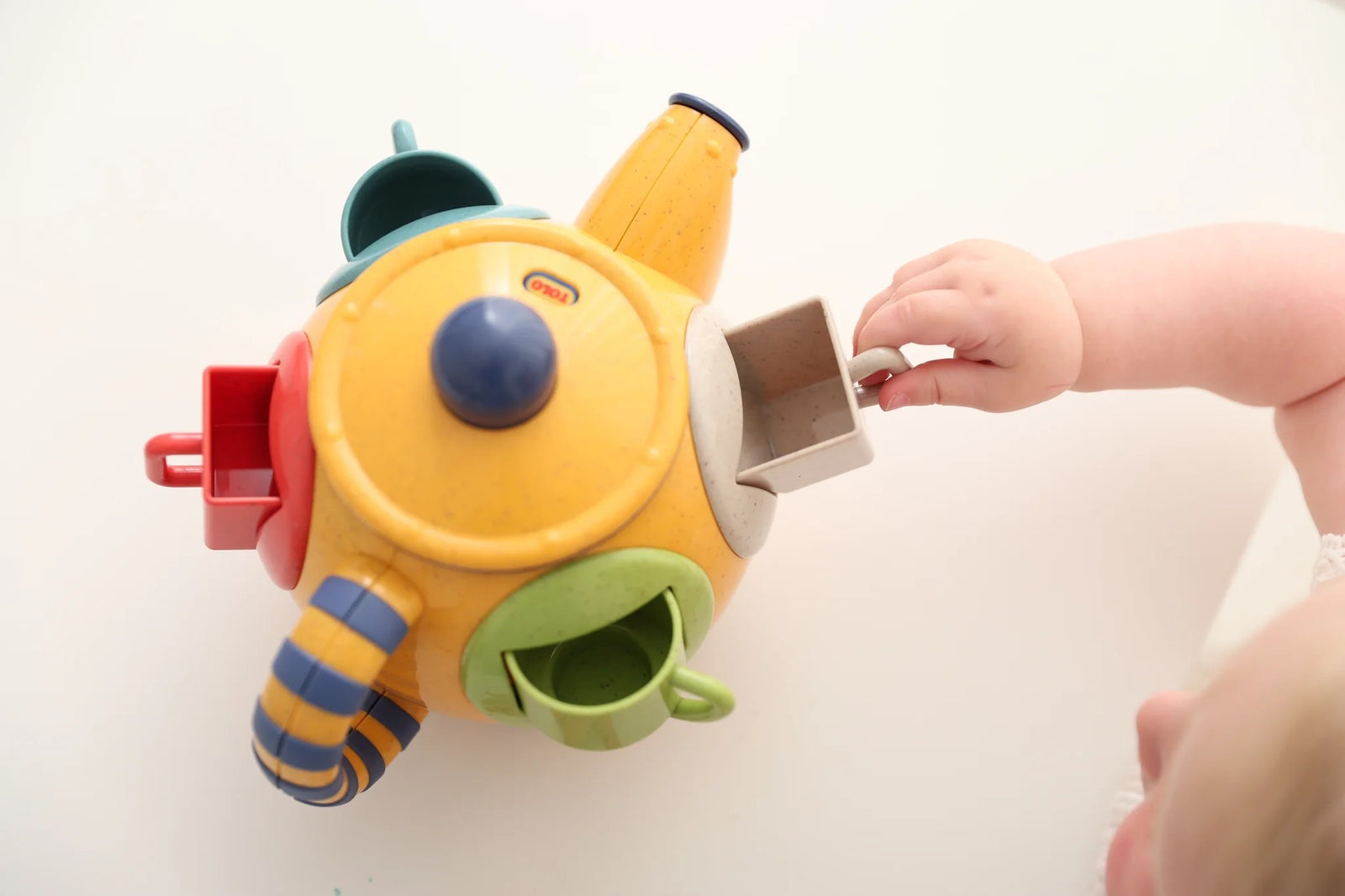 Colorful teapot set with cups on a white background