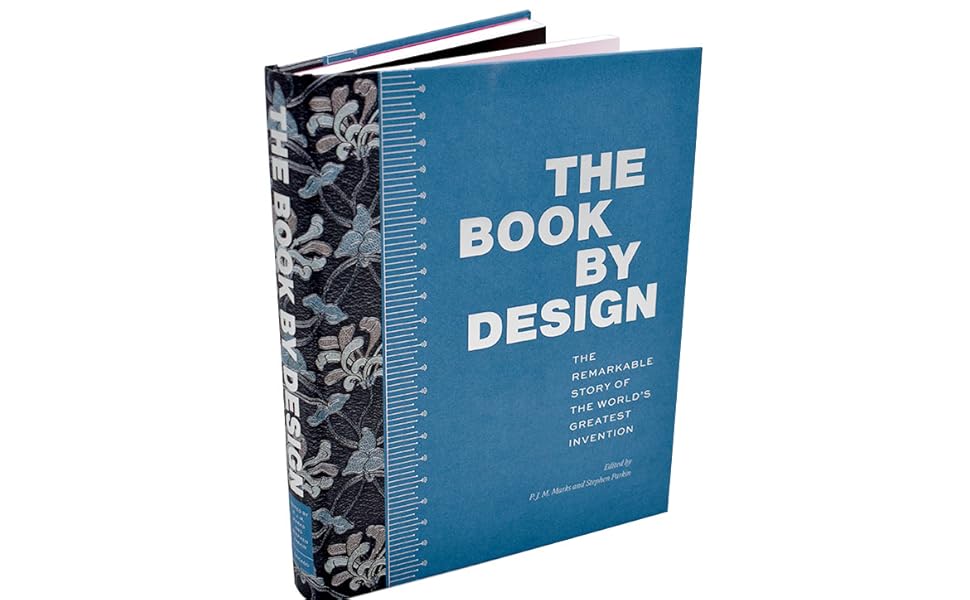 Book titled 'The Book by Design' with a blue cover and white text, open to reveal interior pages.