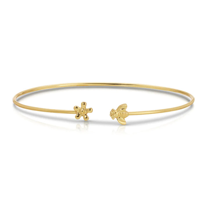 This delightfully dainty 14k gold dipped, nickel-free, cuff bracelet features a tiny bee and flower charm at either end. Fits most wrist sizes and is meant to be stacked. Presented in a pretty gift envelope. 14k gold-dipped brass Adjustable - fits most wrists.