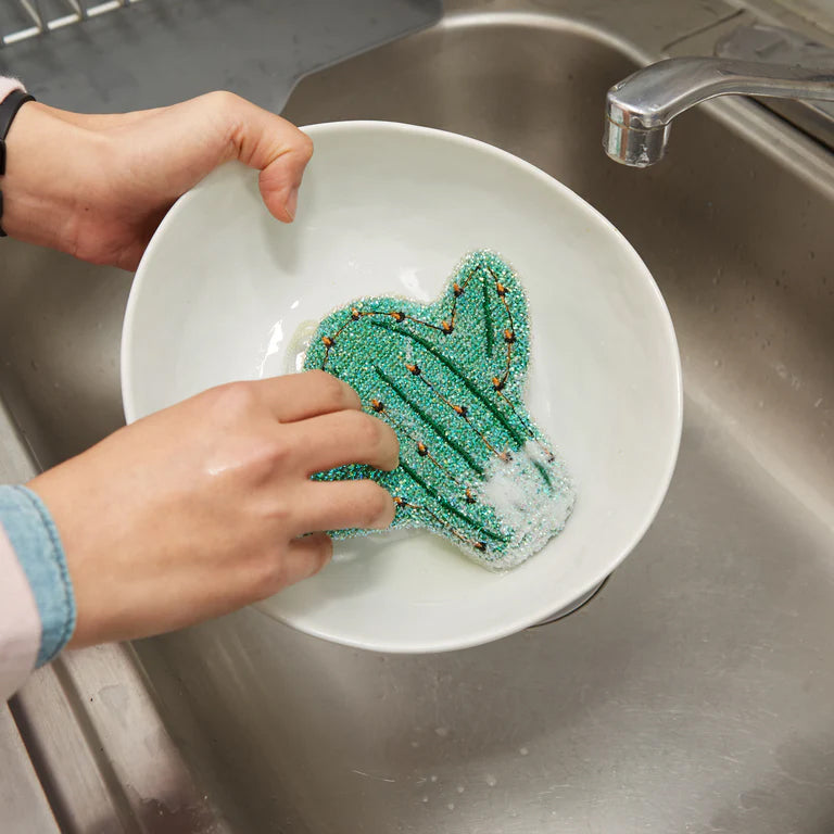 Safely scrub away pesky dried-on food from your dishes with these whimsical cactus-shaped scrub sponges. Great for use on crockery and pans, and will not scratch. Safe on all dinnerware and cookware surfaces Set of two sponges Size: 4: x 5"