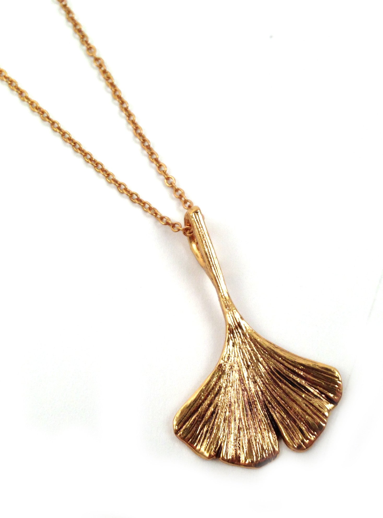 Give the gift of artisan jewelry with this beautifully deigned necklace, cast directly from ginkgo trees at The Huntington! Material: gold-plated pewter Chain Length: 18" Made in the USA Matching earrings available The Ginkgo has been present on Earth for nearly 60 million years and is considered a "living fossil".