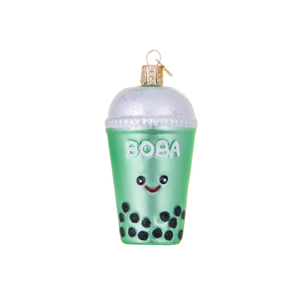 Bonkers for Boba? Then this is the ornament for you. This cute cup has a sweet smiley face, tea-green body, a sparkly lid, and of course, lots of bobbly boba! Glass Hand-painted Hand-glittered Size approx 4" x 2"
