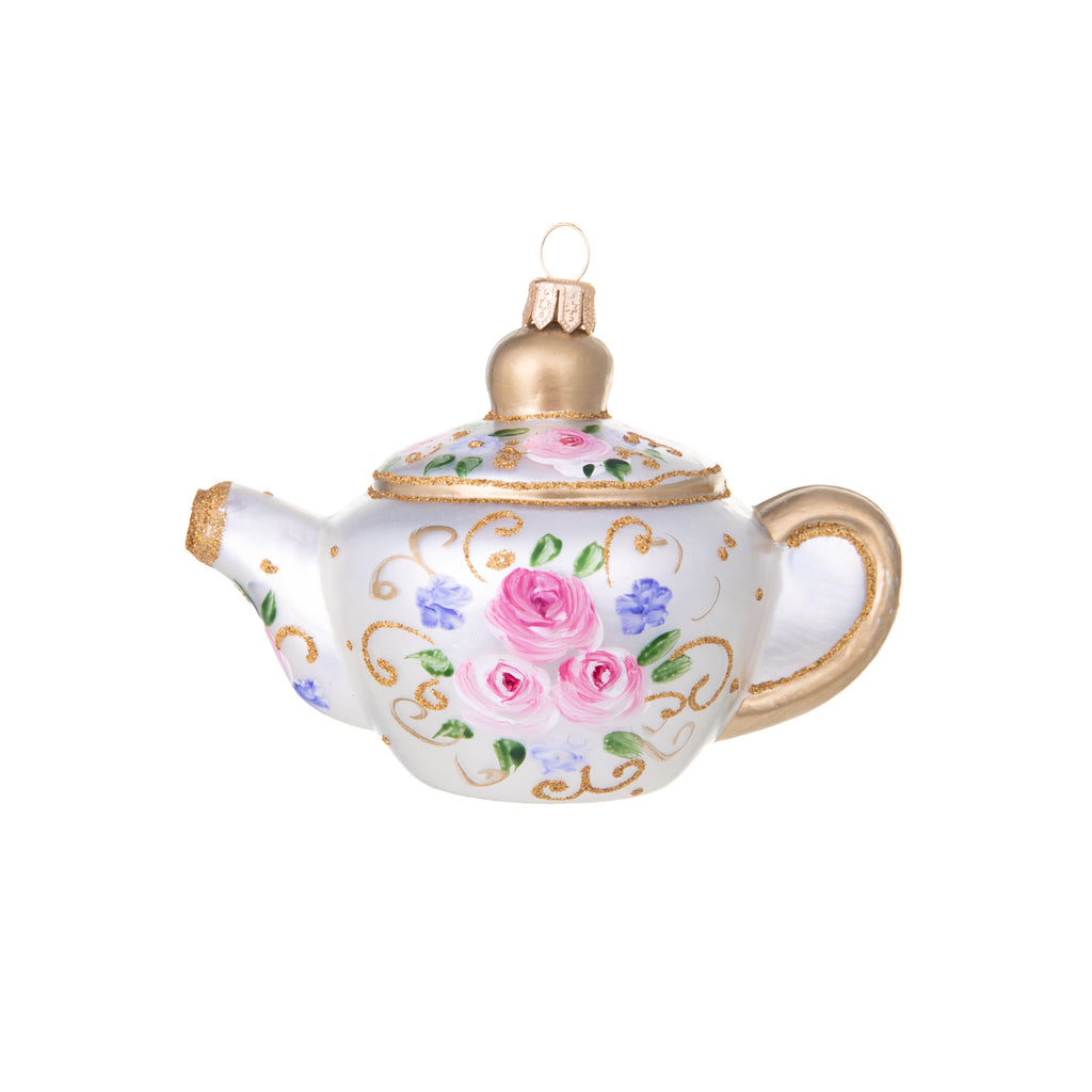 It's always time for tea with this beautiful, hand-painted teapot ornament. This pretty pearly pot is delicately adorned with pink roses and lilac forget-me-nots, all accented with just the right amount of gold sparkle. Glass ornament Hand painted Size approx 4.5" x 3.5"