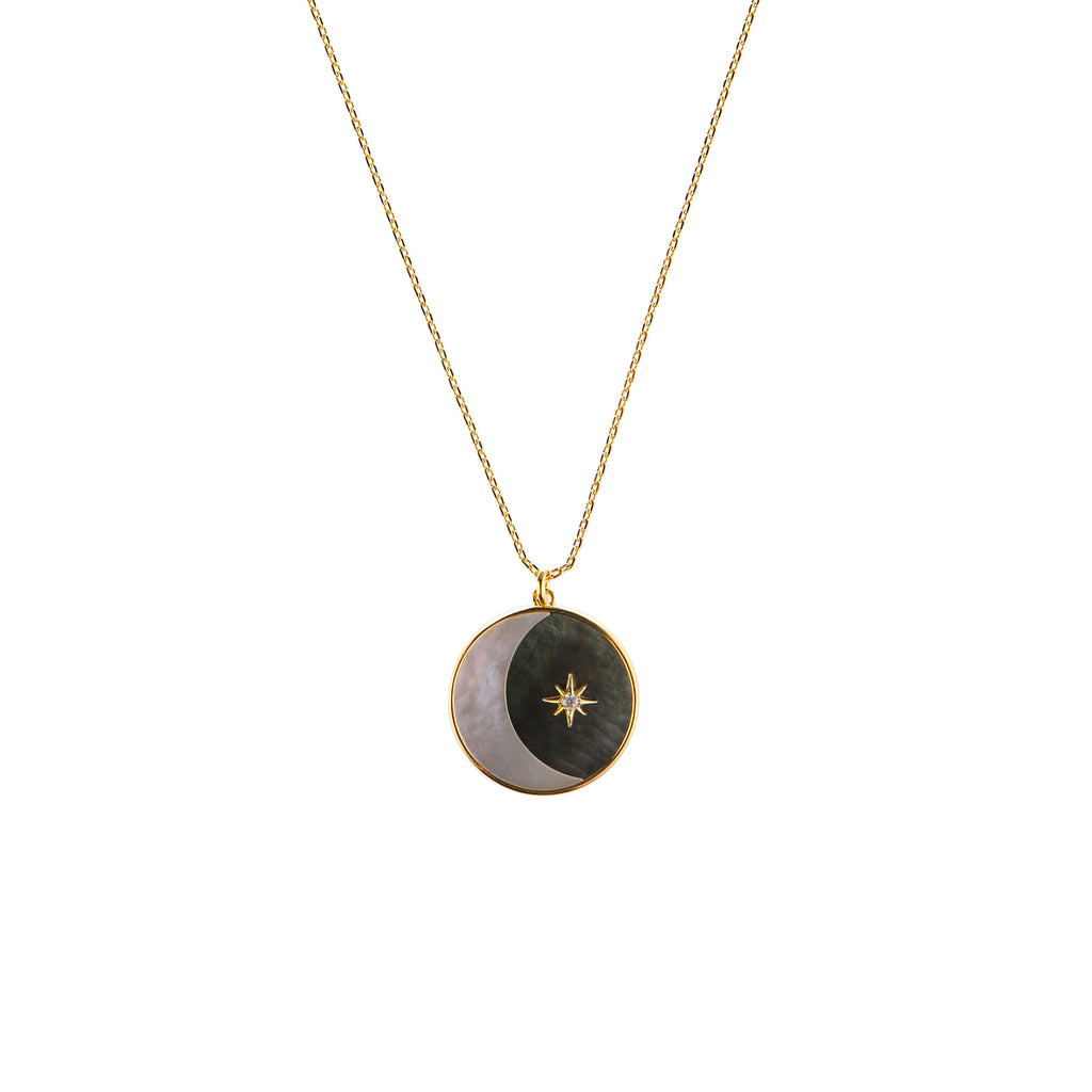 Round pendant necklace featuring a crescent moon in the nights sky, made of mother-of-pearl and abalone. A single, celestial star in gold plated brass with a sparkling CZ stone accent adds the finishing touch to this pretty piece.  Chain is 16" long, adjustable to 18".